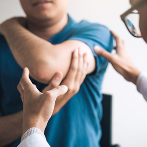 Physical therapist checking patients elbow