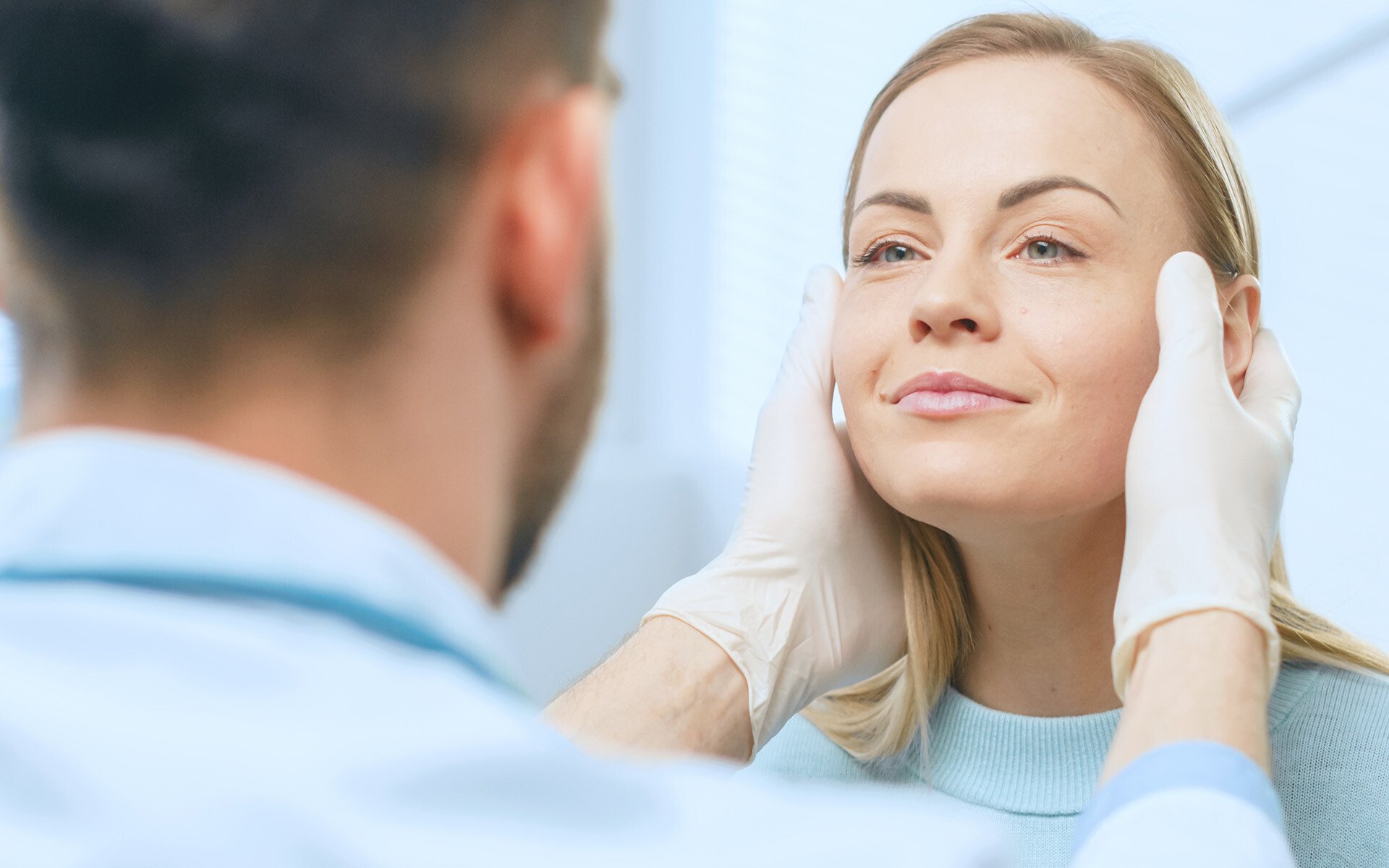 Plastic Cosmetic Surgeon Examines Beautiful Womans Face, Touches it with Gloved Hands, Inspecting Healed Face after Plastic Surgery with Amazing Results