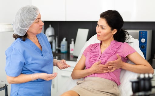 asian woman discussing breast implant procedure with nurse