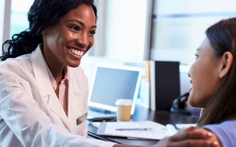 surgeon assuring female patient