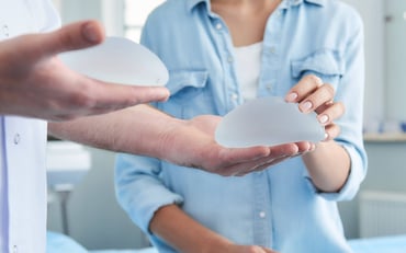 woman examining breast implants (1)