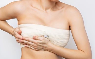 woman holding breast contour